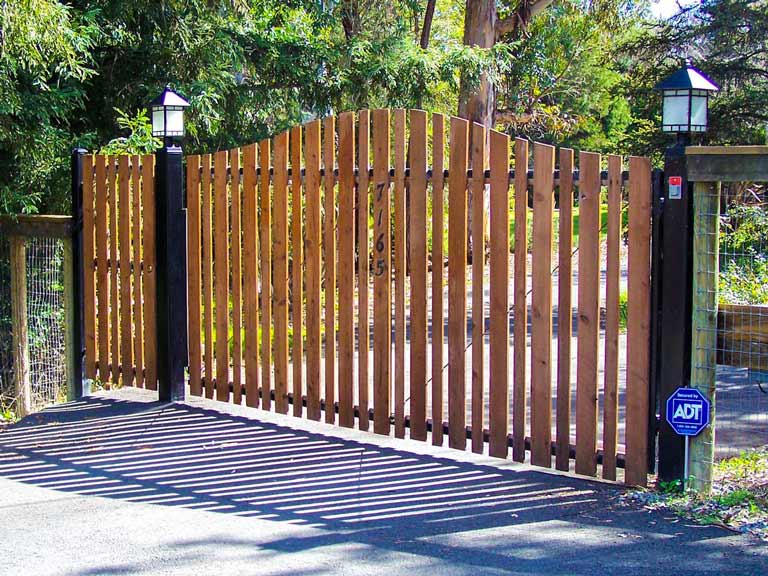 DiFranco Gate & Fence - Residential & Commercial Custom Automated Gate Contractor - Arched top cut redwood picket-single swing-on pc black steel frame automatic gate automatic gate - Forestville CA